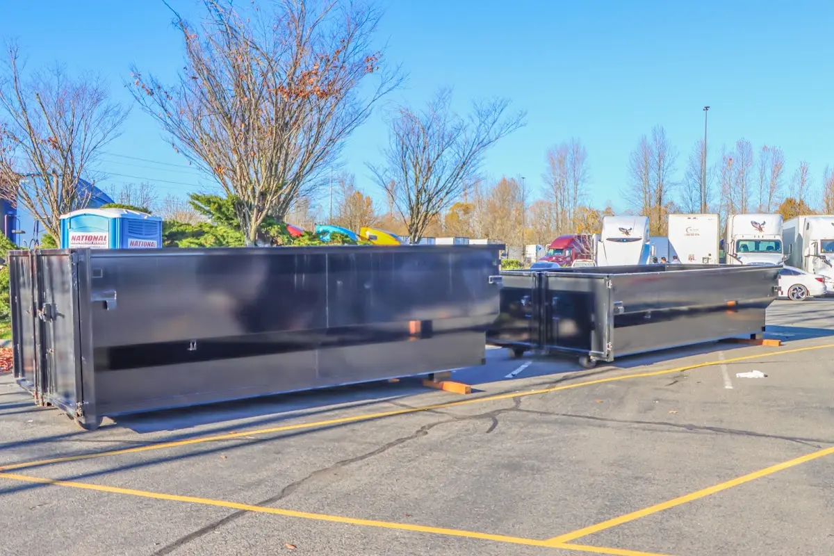 Professional dumpster rental service with roll-off container on residential driveway in Southborough